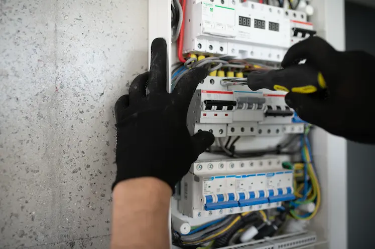tecnico elettricista d'urgenza lavora sul quadro elettrico in palazzo storico di Torino